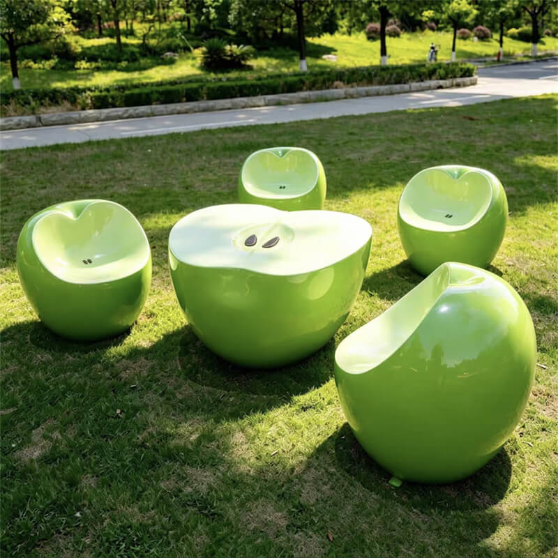 Realistic green‑apple‑shaped fiberglass furniture with rounded cut‑surface design, outdoor lawn leisure set