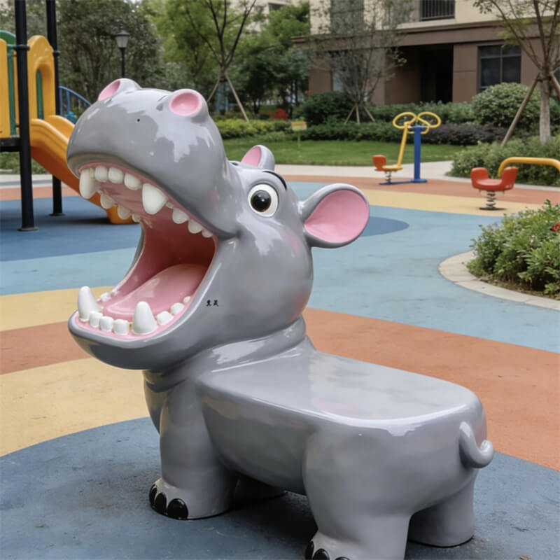 Hippo-shaped fiberglass bench, cartoon animal bench with an open mouth design, outdoor playground setting