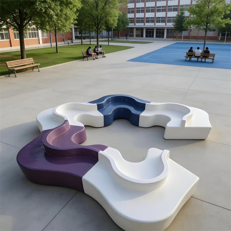 Purple and blue star-shaped fiberglass outdoor bench in a school playground