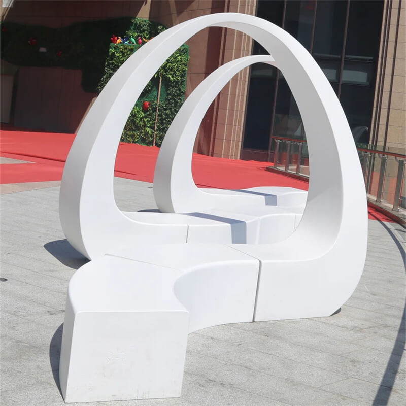 Front close-up oversized single arch fiberglass bench seamless integrated curved fiberglass stool event lawn display statue
