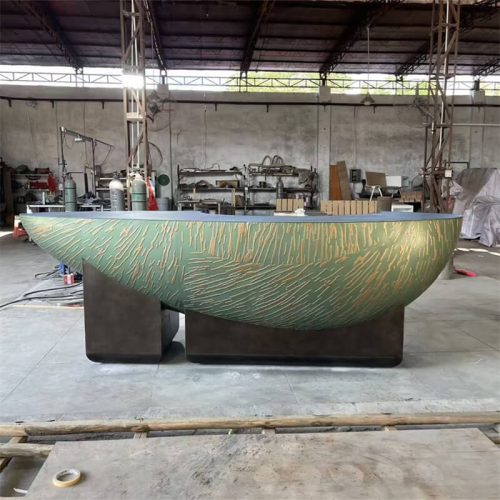 Curved reception desk with teal and gold textured veneer, made of MDF
