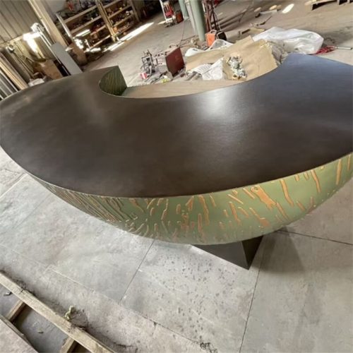 Top view of reception desk, showing dark matte surface and curved shape