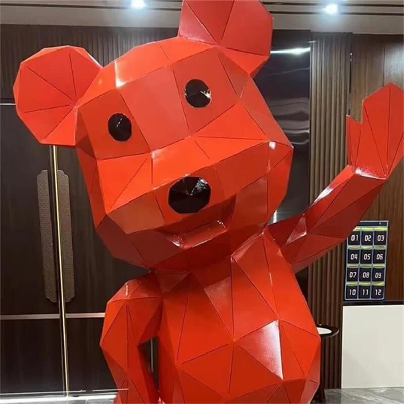 Close up of geometric bear sculpture faceted polygon design red paint