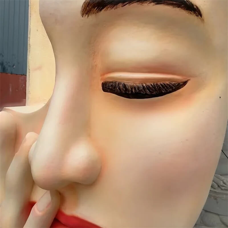 Close up of realistic face sculpture with detailed eye and lip makeup