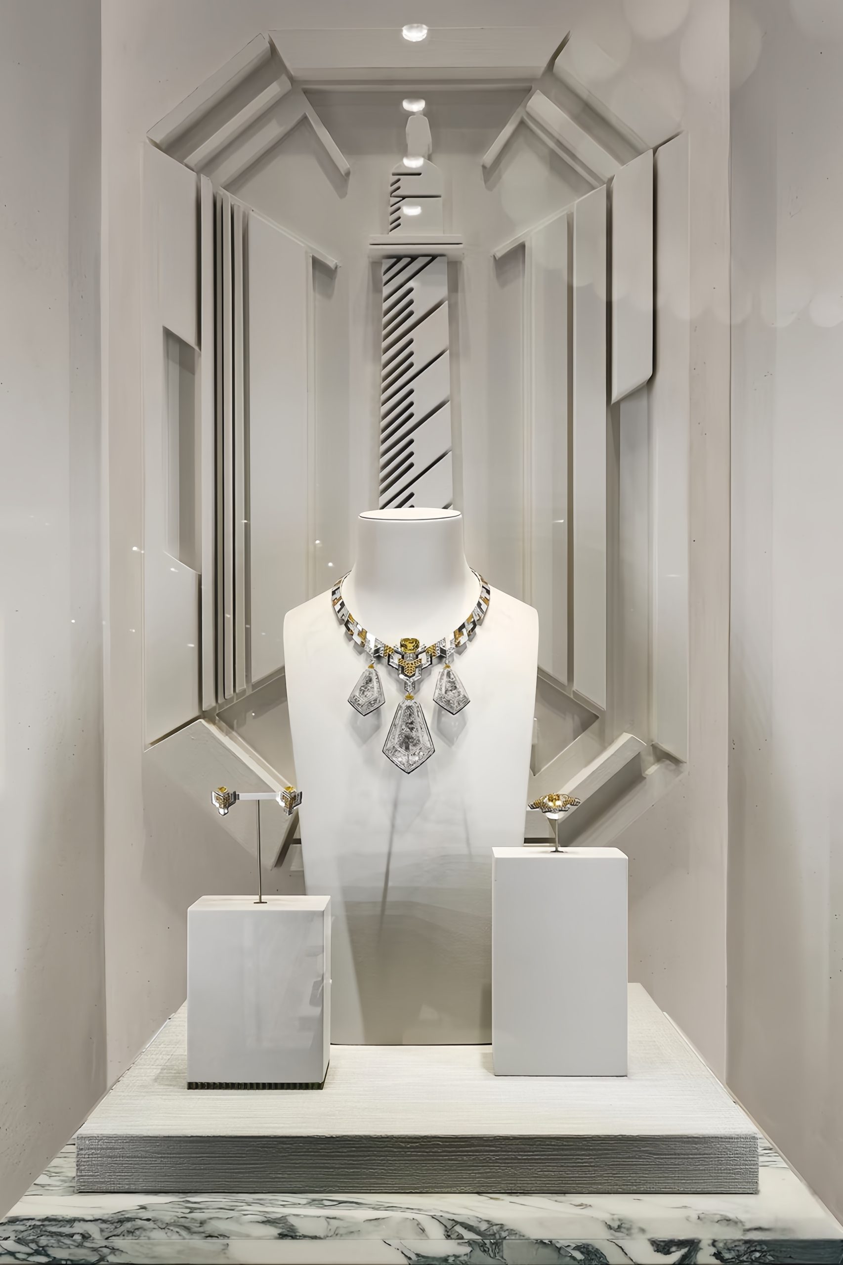 White glass luxury jewelry display vitrine for high‑end jewellery boutique interior