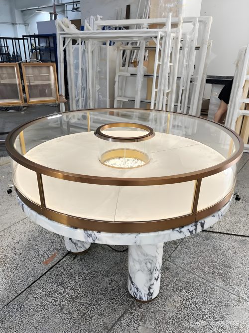 Round marble jewelry island display table, gold metal frame 360‑degree glass showcase with built‑in LED light for luxury jewellery shop
