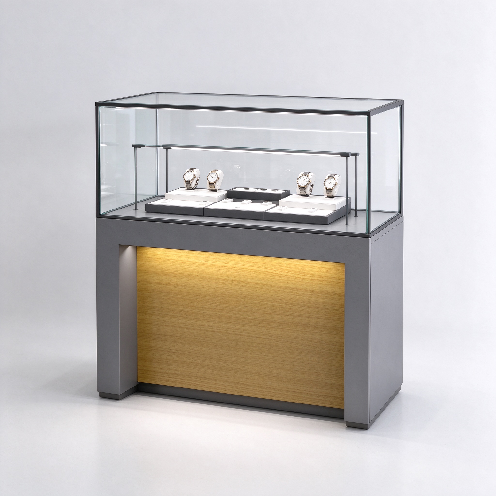 Gray watch display counter with black-frame glass showcase and backlit gold wood panel, left 45 degree view
