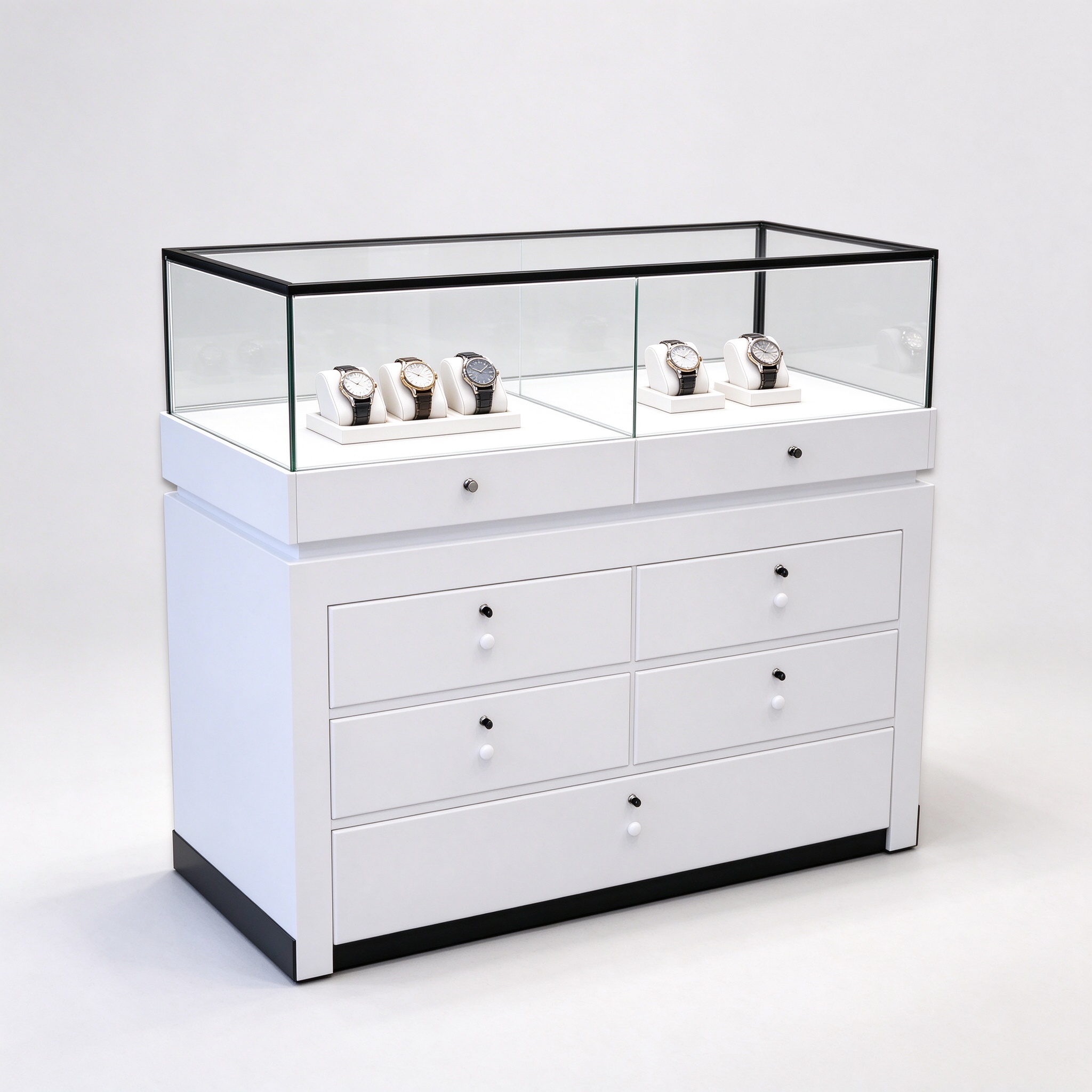 White watch display counter with black-frame glass enclosure and multi-drawer storage, left 45 degree view