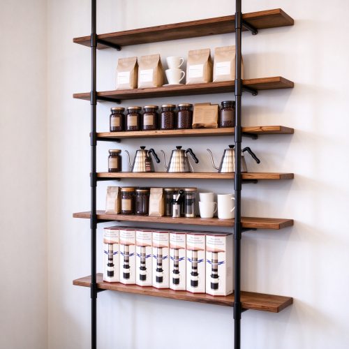 Wall-mounted coffee shop shelving rack with black metal frame and wood shelves, right 45 degree view