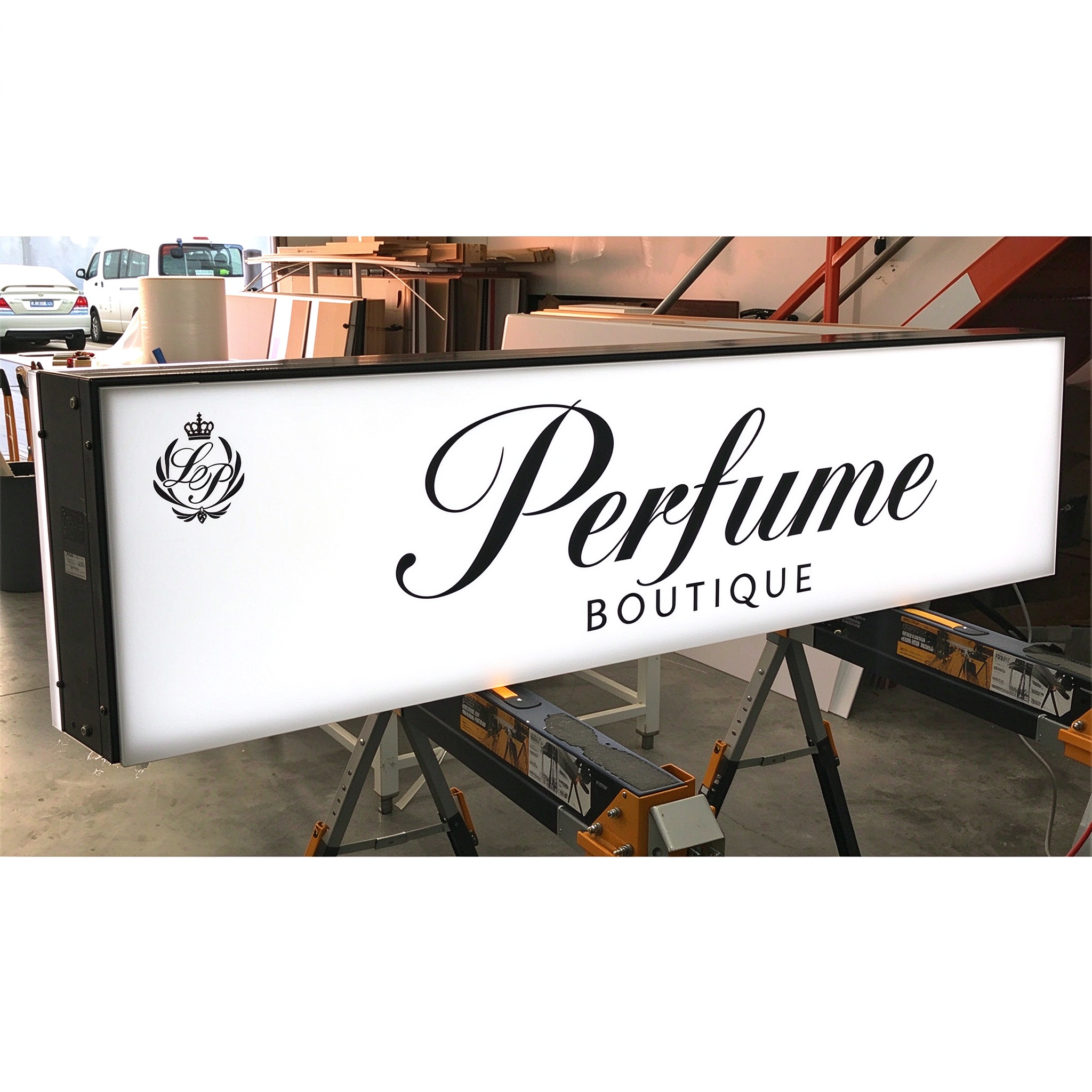 Rectangular LED projecting light box sign with Perfume script, left 45 degree view